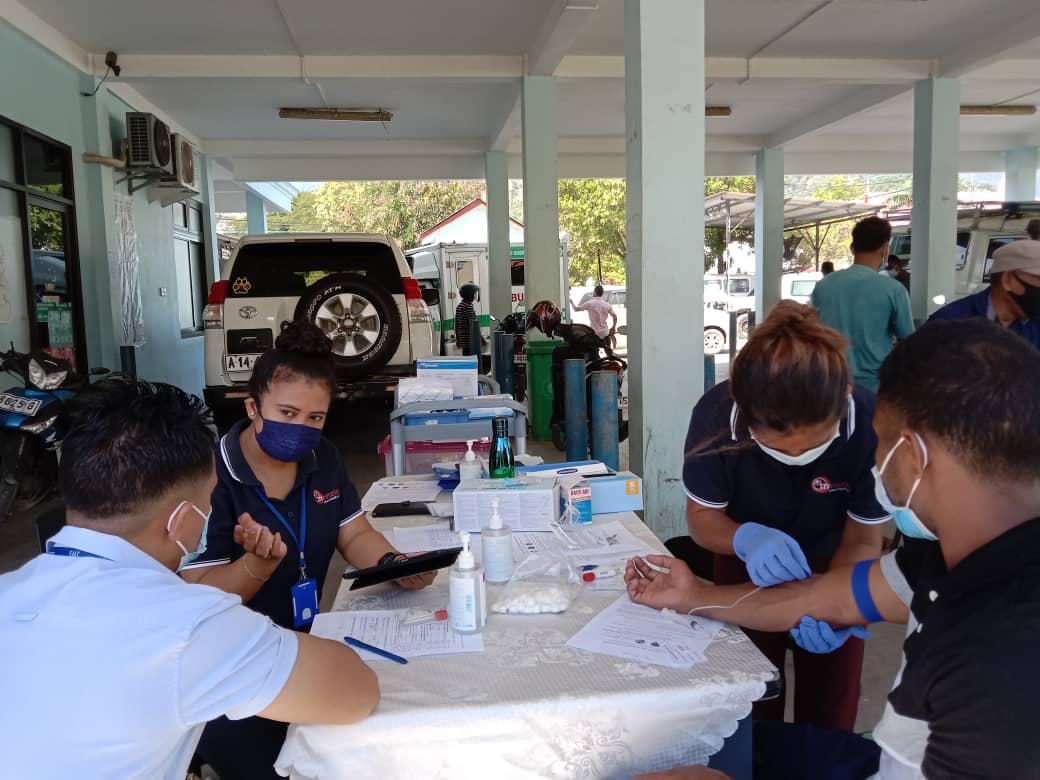 Researchers from Menzies School of Health research collect sample from study participants 